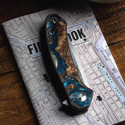 Carved Damascus Pocket Knife on Map