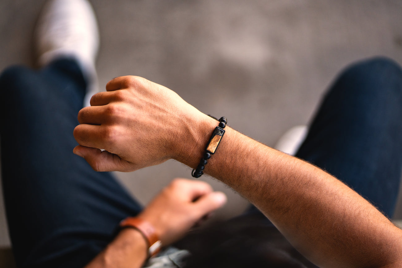 Persons arm wearing onyx bead bracelet