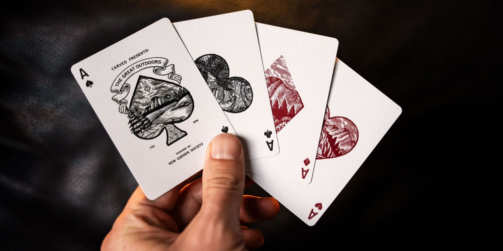 4 playing cards being held in a hand